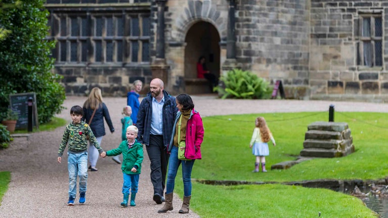 Visitors outside the front of East Riddlesden Hall in Yorkshire